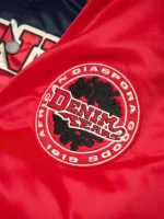 Detailed design view of the Denim Tears Baseball Varsity Jacket.