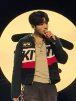 Jungkook performing on stage with microphone in black Kith jacket at BTS Swimside Event 2026