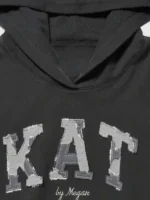 A detailed macro shot of the premium fabric blend and fine stitching on the Gap x Katseye Megan Hoodie.