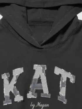 A detailed macro shot of the premium fabric blend and fine stitching on the Gap x Katseye Megan Hoodie.