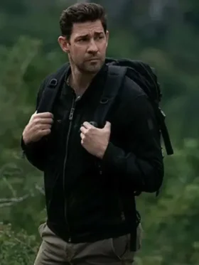 John Krasinski as Jack Ryan in black cotton jacket from Tom Clancy's Jack Ryan Season 3 with tactical backpack in forest
