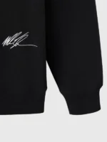 A detailed macro shot of the embroidery and textile grain on the OVO Tyson Tattoo OG Hoodie.