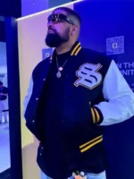 A side profile of the Solflare Black and White Varsity Jacket showing the contrast between the dark body and light sleeves.