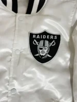 A detailed macro shot of the premium fabric weave and hardware on the Tom Brady White Raiders Jacket.