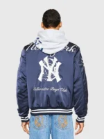Male model back view in BBC x NY Yankees navy satin stadium jacket with Billionaire Boys Club branding and NY graphic