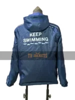 Back view of BTS Keep Swimming jacket showing text and wave graphic in deep blue