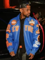 Fabolous wearing the New York Knicks 2025 Pelle Pelle blue and orange leather jacket with Eastern Conference and We Run New York sleeve detailing