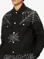 King Spider x Young Thug black rhinestone denim jacket on male model showing chest web embroidery and sleeve detail