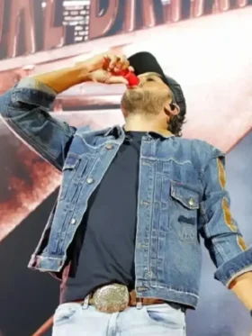 Luke Bryan wearing blue denim trucker jacket on stage at Sanford Stadium concert tour with buttoned closure and shirt collar