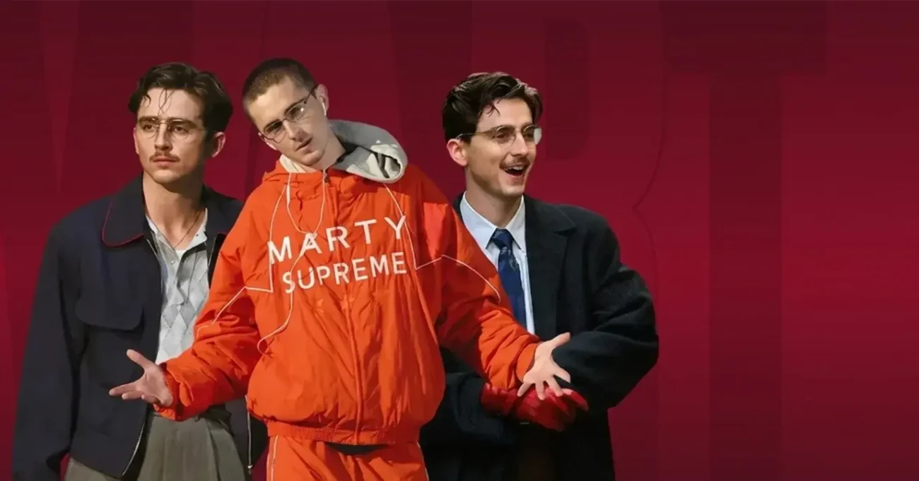 Three male models wearing Marty Supreme jackets including orange Marty Supreme windbreaker, navy jacket and black suit at TVJackets