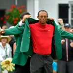 Golf champion arms wide open receiving the Masters green blazer during the Augusta National award ceremony