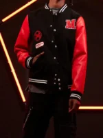 Front on-model view of Miles Morales varsity jacket showing M letter patch, spider symbol patch, Brooklyn patch, silver snap buttons and red leather sleeves