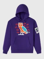 Full front flat lay of OVO x The Joker 2026 purple pullover hoodie showing OVO owl chest graphic Joker sleeve patch and kangaroo pocket