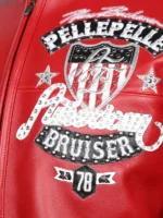 Close-up of Pelle Pelle American Bruiser chest shield with rhinestone script and 78 badge on red leather jacket