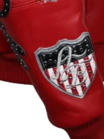 Close-up of American Bruiser shield patch on sleeve of Pelle Pelle red leather jacket with red and white stripe detail