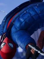 Miles Morales Spider-Man swinging upside down in electric blue puffer jacket against blue sky in PS4 game