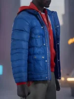 Side angle of Miles Morales blue puffer jacket open showing zipper snap-tab detail and chest pockets with red hoodie underneath