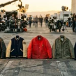 Five jackets from The Fall Guy 2024 cast outfits collection lined up on a Hollywood film set, including leather, varsity and red jacket styles