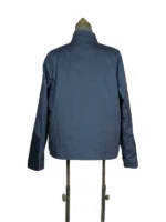 Rear view of the dark blue fabric Captain America The Winter Soldier Chris Evans jacket on a tailor's dress form with a white studio backdrop.