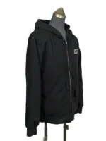 Side angle detail of the heavy cotton black terry hoodie showing the premium ribbed cuffs and deep kangaroo pocket.