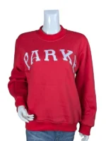 Front view of a red mockneck sweatshirt on a mannequin featuring a curved chest embroidery of varsity block letters outlined in white.