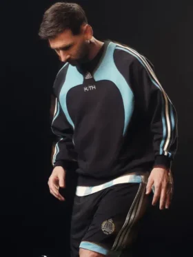 A premium standalone profile presentation of the black and blue Adidas Kith Lionel Messi Fleece Sweater.
