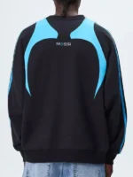 Clean rear profile view showing the striking color block distribution of the Adidas Kith Lionel Messi Fleece Sweater.