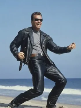 Arnold Schwarzenegger as T-800 in black leather jacket and trousers with sunglasses laughing on beach from Terminator 2 1991