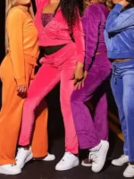 Close-up view of Cheetah Girls Tracksuit Costume in orange, pink, purple, and blue velvet color options