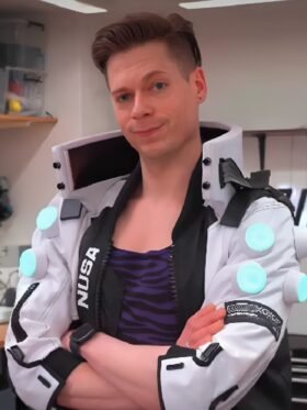 Cyberpunk 2077 NUSA Infiltrator cosplay jacket front view showing NUSA branding stand-up collar teal arm elements and front zipper