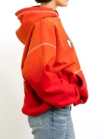 A vibrant orange and red gradient view of the Monster Heavy Hood.