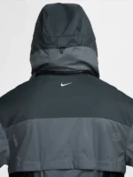 Back hood detail of Nike ISPA Butterfly Jacket Anthracite Dark Grey showing structured hood buckle rear zip seam and Nike Swoosh on upper back