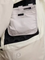 Open modular cargo pocket on Nike ISPA Butterfly Jacket Orewood Brown showing interior zip compartment and ISPA logo dot-print on lower panel