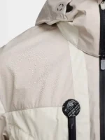 Water beading on Nike ISPA Butterfly Jacket Orewood Brown shoulder panel showing DWR water-repellent recycled nylon surface with ISPA brand badge
