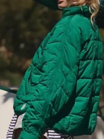 A tailored side perspective view showcasing the sleek quilted volume of the Pippa Packable Dark Green Puffer Jacket.