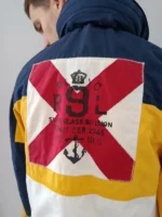 Polo Ralph Lauren Yacht Club Sailing Jacket back view worn by model showing R9L Snipe Class Division red cross anchor patch navy yellow white colorblock