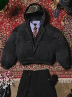 Black Shinzo Shige canvas clasp bomber jacket on mannequin against ornate floral red rug background