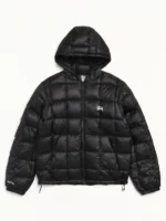 Front view of black Stussy Hooded Puffer Jacket with quilted nylon design and hooded collar