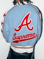 Back view of Supreme Mitchell Ness Braves powder blue varsity jacket with oversized red A logo and Supreme script