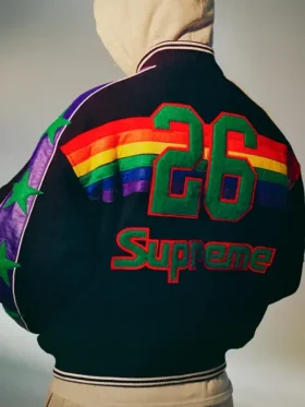 Back view of Supreme x Mitchell & Ness Denver Nuggets black varsity jacket showing number 26 in green and Supreme script above rainbow stripe