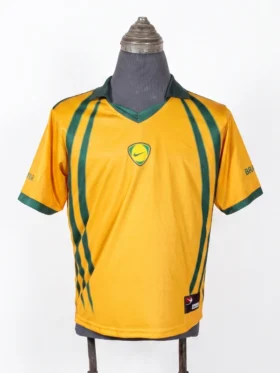 Full front view of the yellow Cactus Jack x Nike Brasil Total 90 retro jersey on a mannequin against a white background.