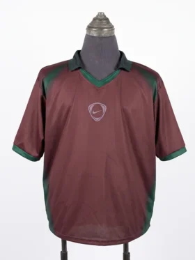 Full front view of the maroon and green CJ x Nike Portugal Total 90 Retro Jersey on a mannequin torso.