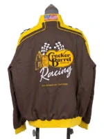 Rear view of the brown cotton NASCAR Cup Series Cracker Barrel 400 Racing Jacket on a mannequin, highlighting the large embroidered yellow Cracker Barrel Old Country Store logo, twin checkered flags, and white "Racing" script above the text "An American Institute.