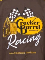 High-resolution macro photograph of the rear embroidery on the Cracker Barrel 400 racing jacket, detailing the stitch quality of the yellow logo oval, corporate branding text, and flowing white cursive typography.