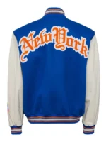 Rear view of the royal blue and cream New York Knicks varsity jacket highlighting the large arched gothic "New York" chenille patch across the shoulders.