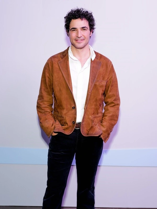 Zac Posen Suede Jacket Fashion designer Zac Posen wearing a tailored brown suede jacket open over a crisp white dress shirt and dark trousers.