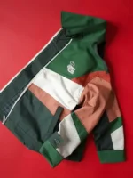 Mauro Garfias x Lacoste Mexico World Cup 2026 jacket flat lay on red background showing back panel green white red clay colour blocking and viscose lining