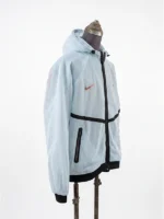 Side view of Nike France mesh anthem jacket in Igloo mint with hood and black trim detail