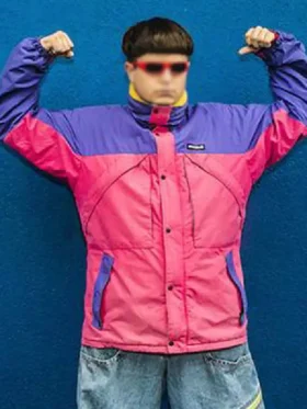Oliver Tree wearing the All That x Alien Boy pink and purple jacket against a blue background