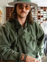Man wearing vintage Swedish military motorcycle jacket army green cotton styled with flat brim hat tinted glasses and casual layering